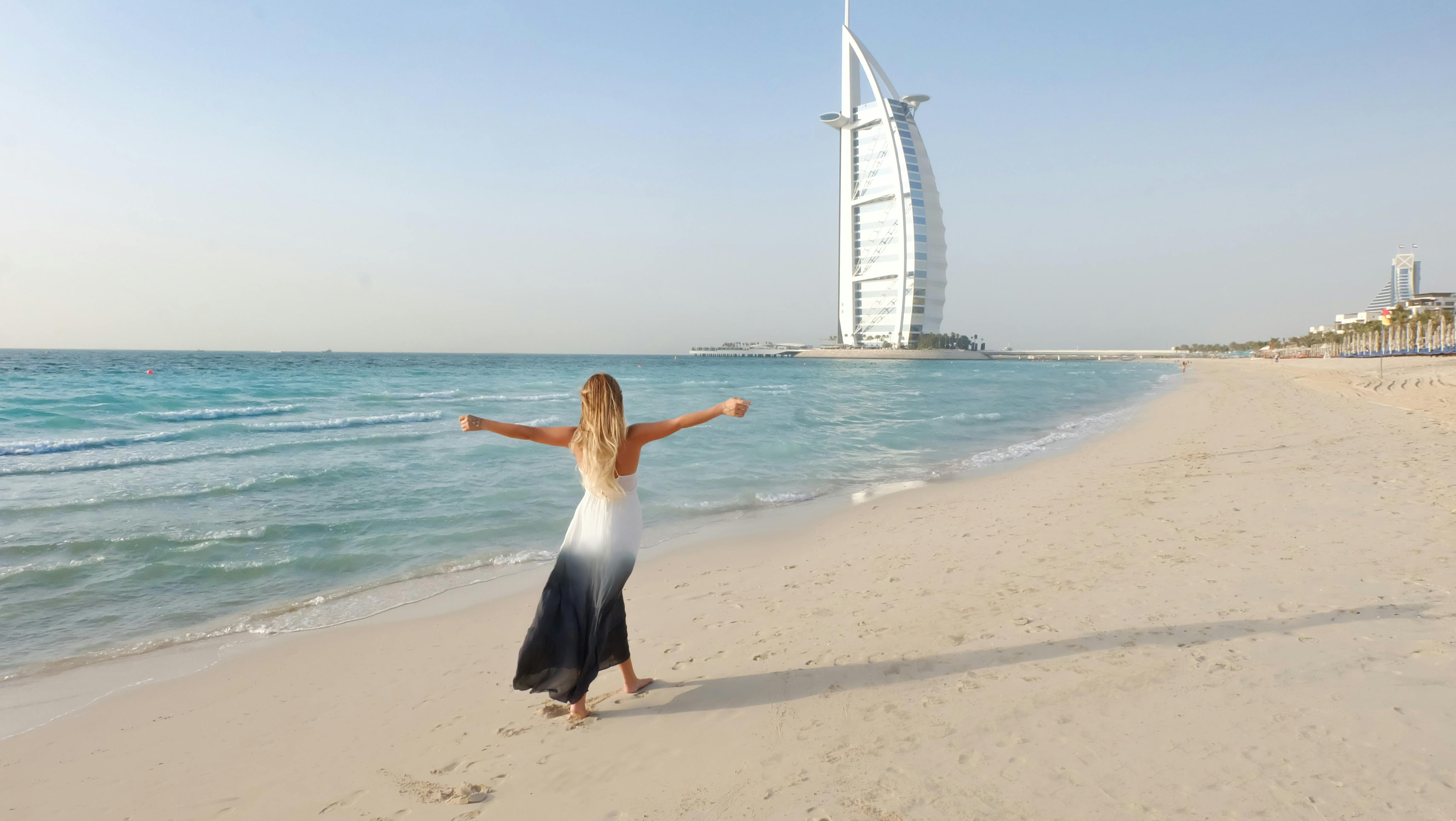Luxury Dubai beach view with Burj Al Arab and palm trees - Arman Vacation Homes